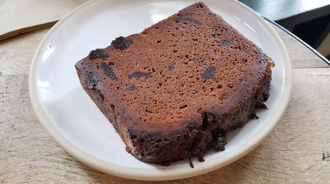 Rich dark cocoa artisan bread loaf with deep chocolate crust and crumb