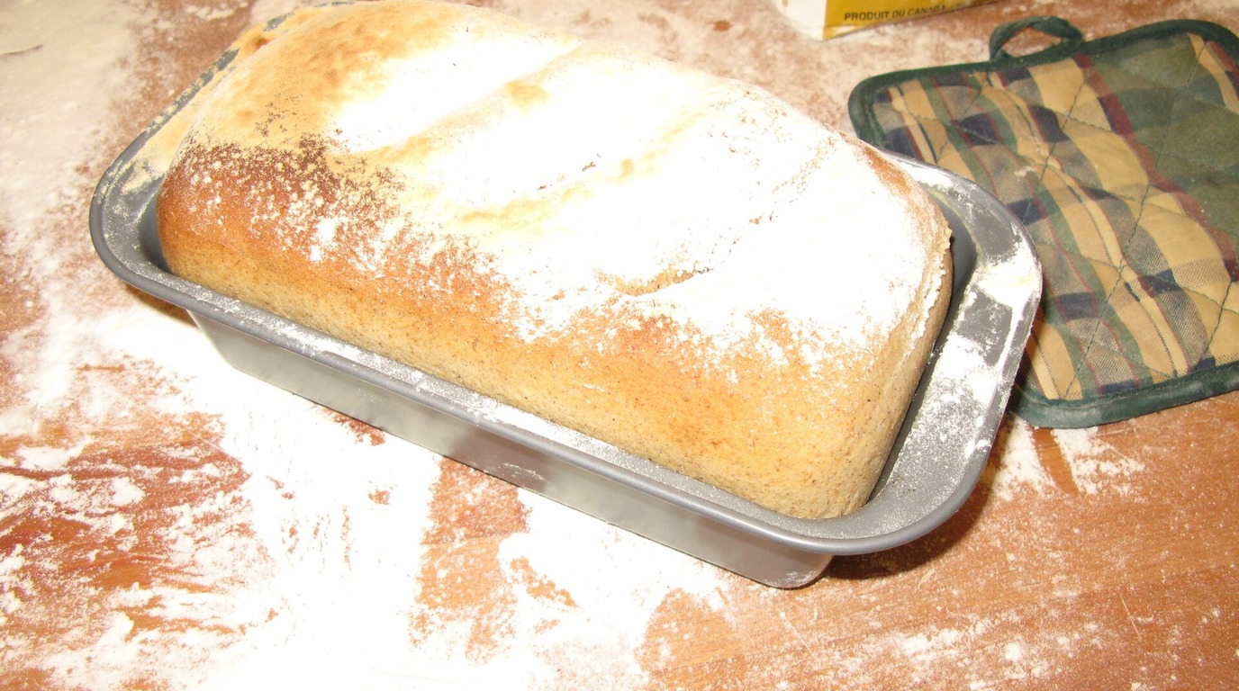 Rustic ancient-grain einkorn bread loaf with warm golden-yellow interior crumb