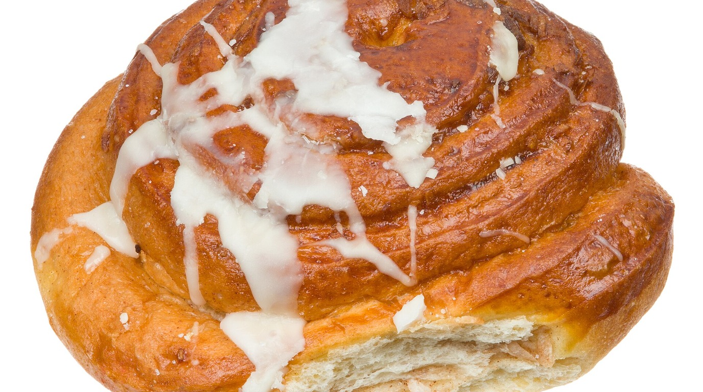 Freshly baked swirled cinnamon rolls with golden brown brioche dough and sweet glaze
